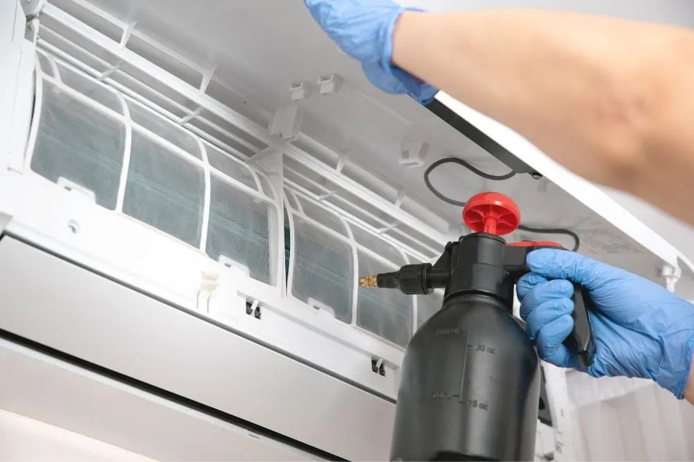 Air conditioning technician at work on an outdoor unit