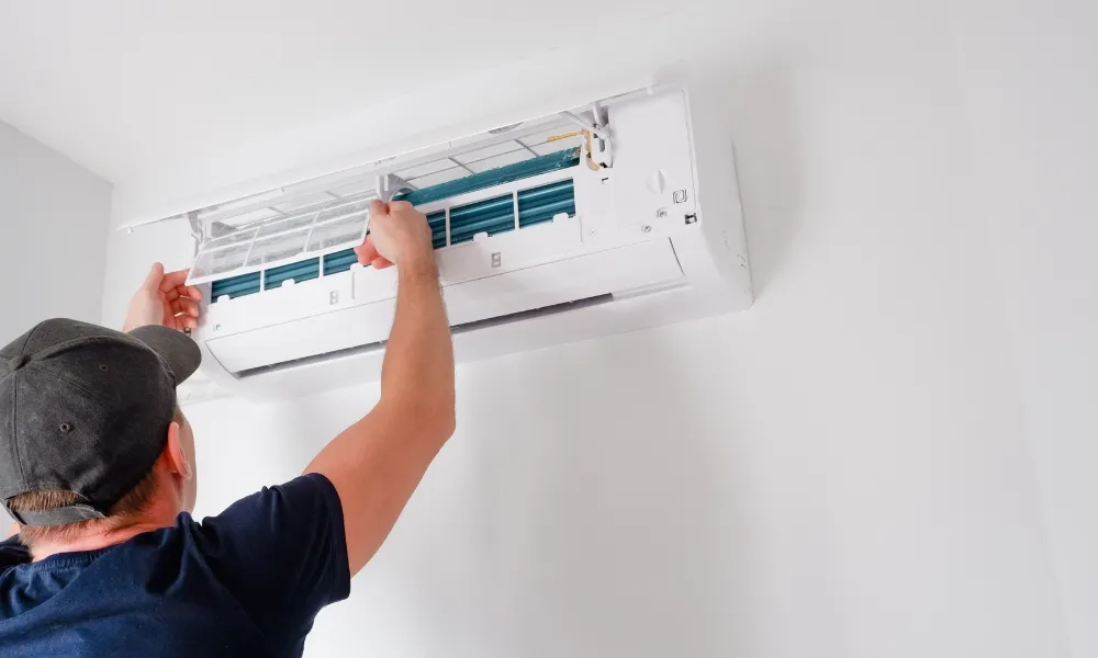 Man holding the filter of the air conditioner
