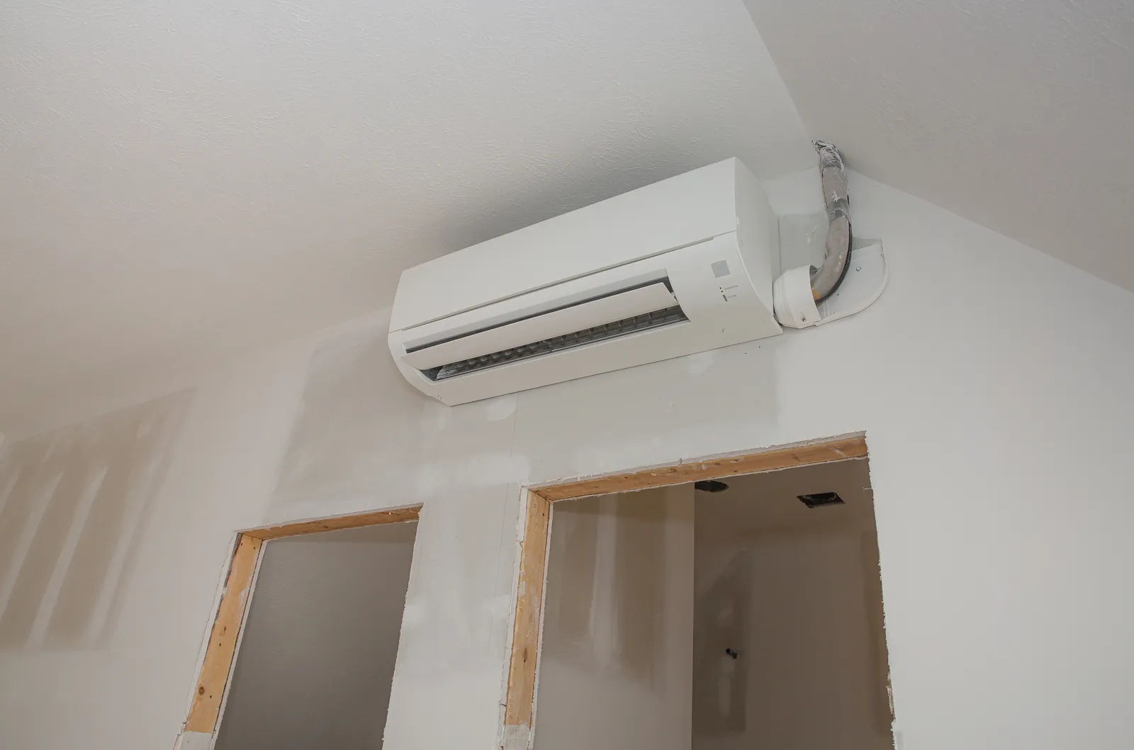 mini split,ductless,air,conditioning,unit,installed,in,unfinished,room